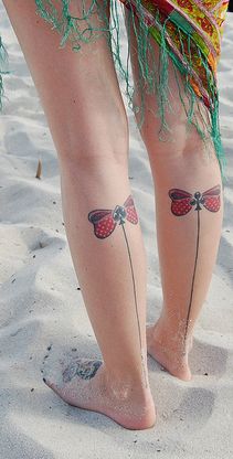 Lovely red bow and line tattoo on leg