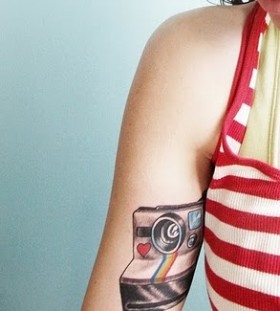 Lovely red heart and rainbow color with camera tattoo on arm