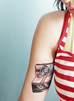 Lovely red heart and rainbow color with camera tattoo on arm