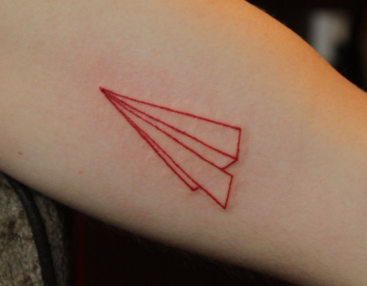 Lovely red plane origami tattoo on arm