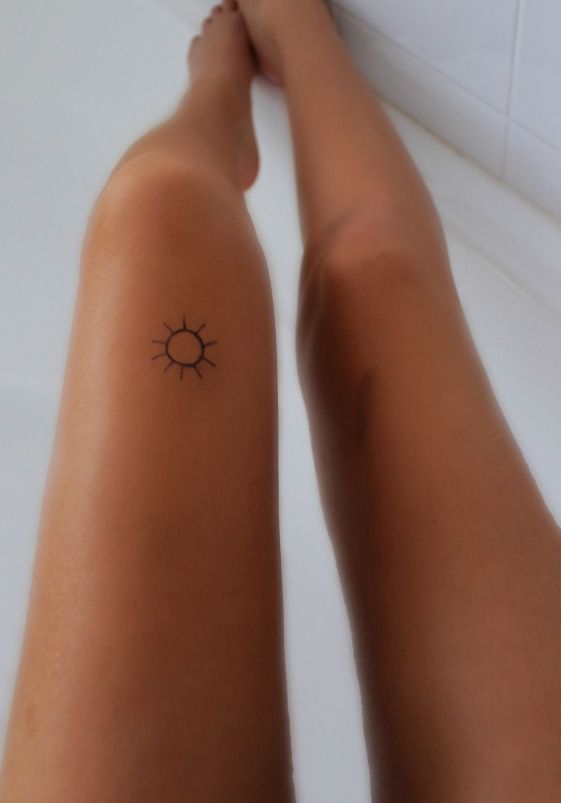 Lovely small sun tattoo on leg