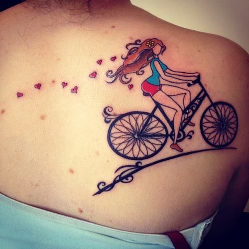 Lovely women hair and bicycle tattoo on back