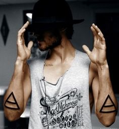 Man with big triangles tattoos