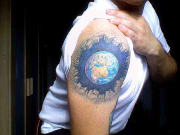 Man with globe tattoo on arm