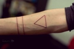 Minimal triangle line tattoo on arm