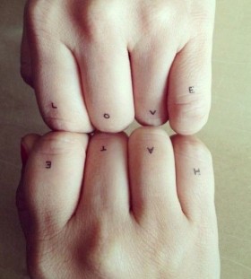 Modern style quote tattoo on finger