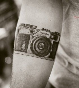 NIkon awesome camera tattoo on arm