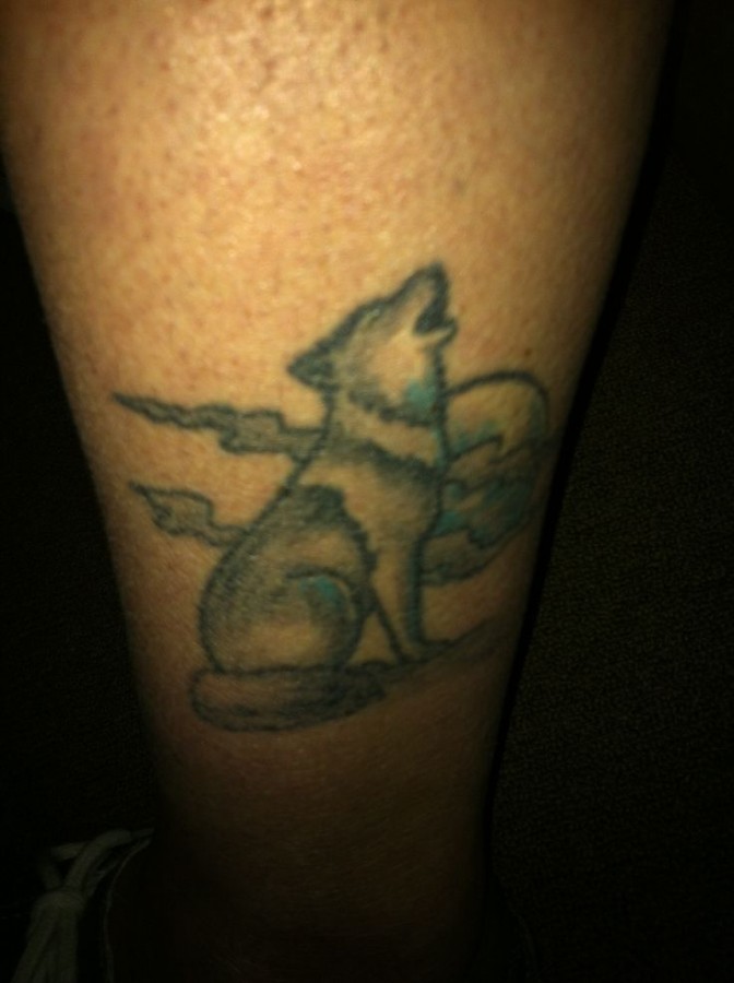 Night and white and black wolf tattoo on leg