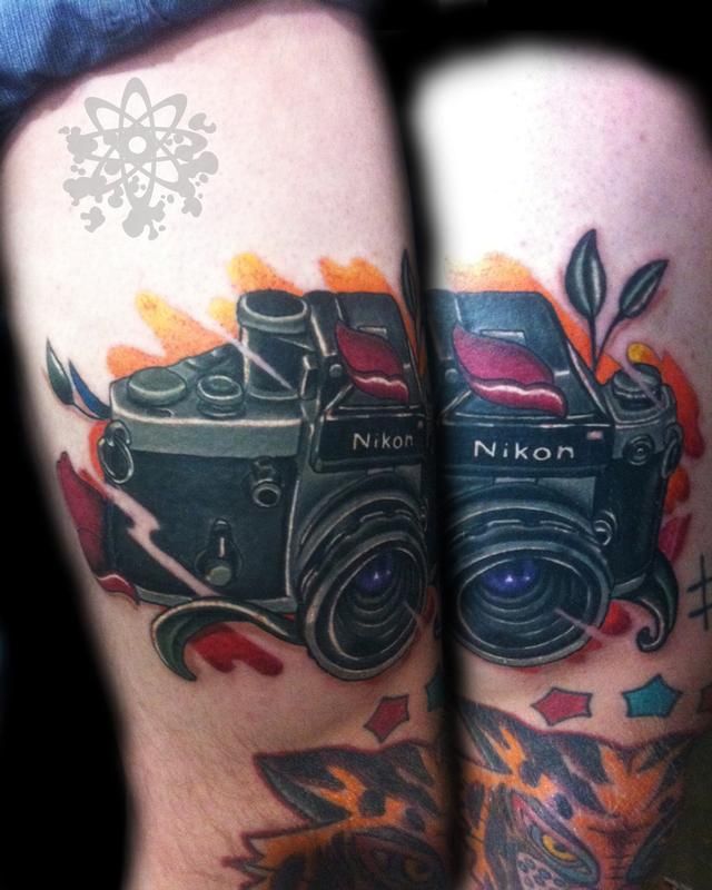 Nikon black and awesome camera tattoo on leg