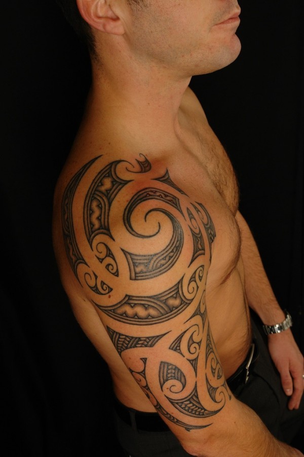 Ornamentally tribal tattoo on shoulder