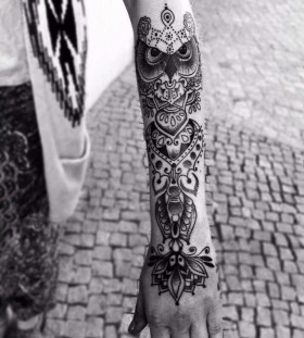 Owl and black lace tattoo on arm