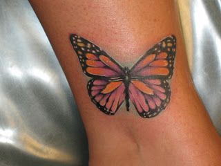 Pink small butterfly tattoo on leg