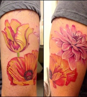 Pink, yellow and orange poppy tattoo on arm