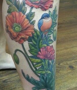 Poppy and blue bird tattoo on leg