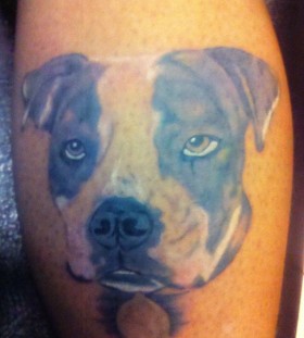 Pretty brown eyes dog tattoo on leg