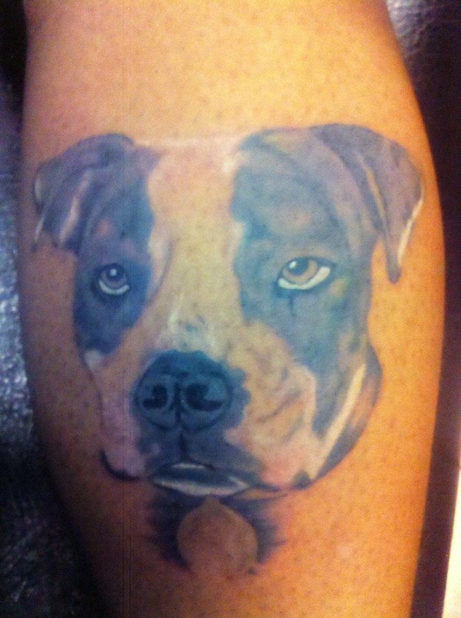 Pretty brown eyes dog tattoo on leg