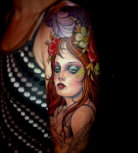 Pretty red hair girl's face tattoo on arm