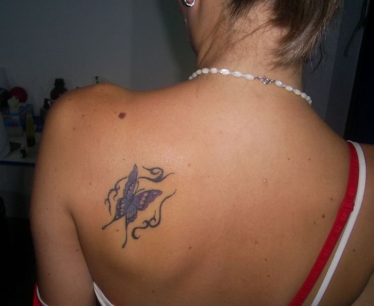 Purple girl butterfly tattoo on shoulder