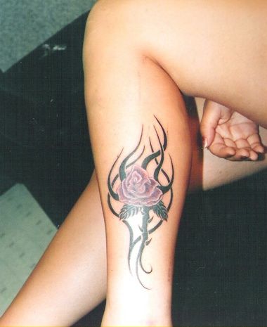 Purple rose and tribal tattoo on leg