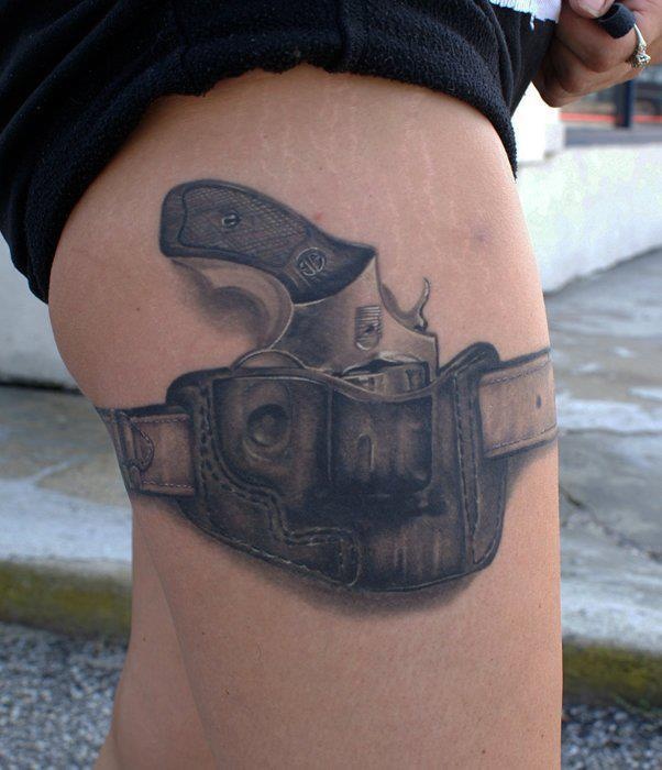 Realistic black gun tattoo