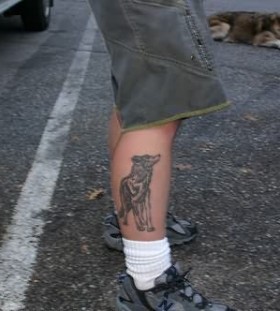 Realistic wolf and wolf tattoo on leg