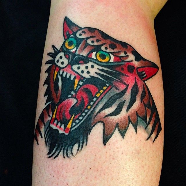 Red and brown tiger tattoo on arm