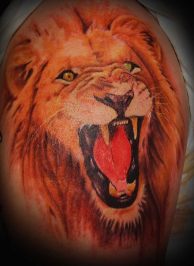 Red angry lion tattoo on leg