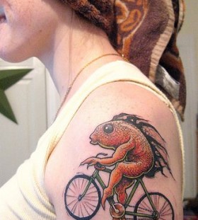 Red fish and bicycle tattoo on arm
