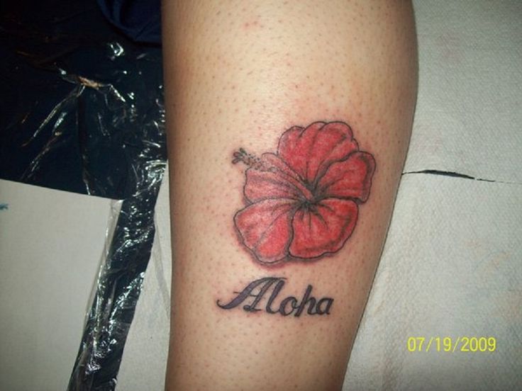 Red flower and quote tattoo on leg