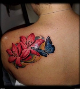 Red flowers and butterfly tattoo on shoulder