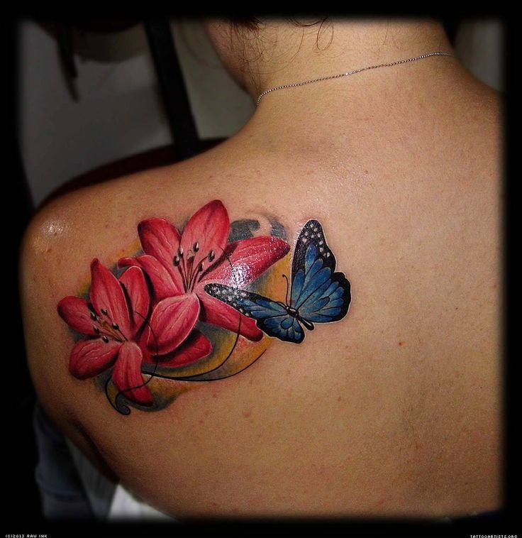 Red flowers and butterfly tattoo on shoulder