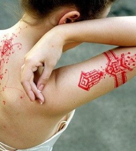 Red girl lace tattoo on arm