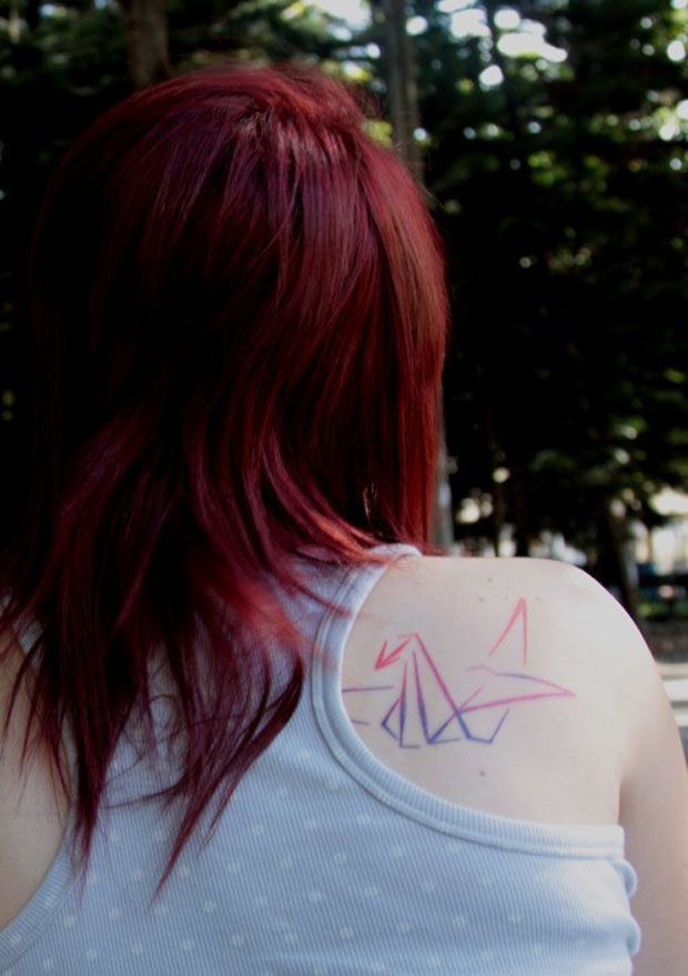 Red hair girl origami tattoo on shoulder