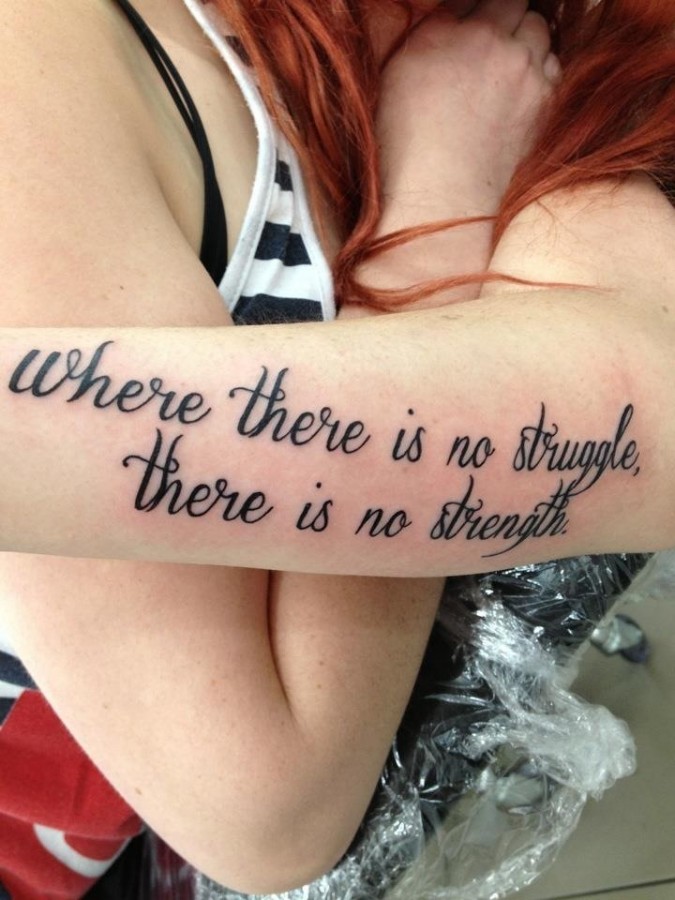 Red hair women quote tattoo on arm