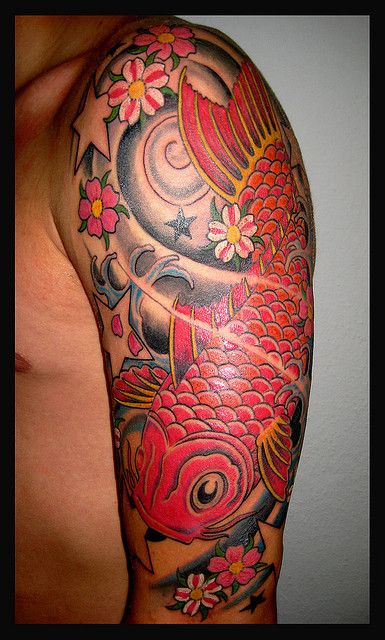 Red lovely fish tattoo on arm