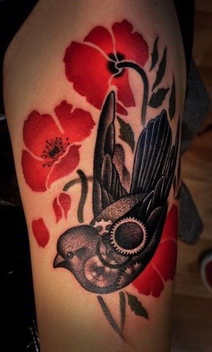 Red poppy and flower tattoo on hand