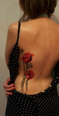 Red poppy watercolor tattoo on girl back