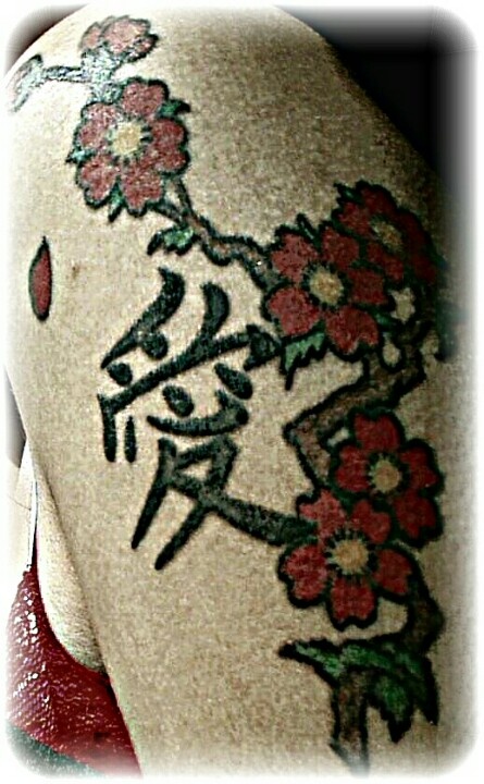 Red pretty cherry tattoo on arm