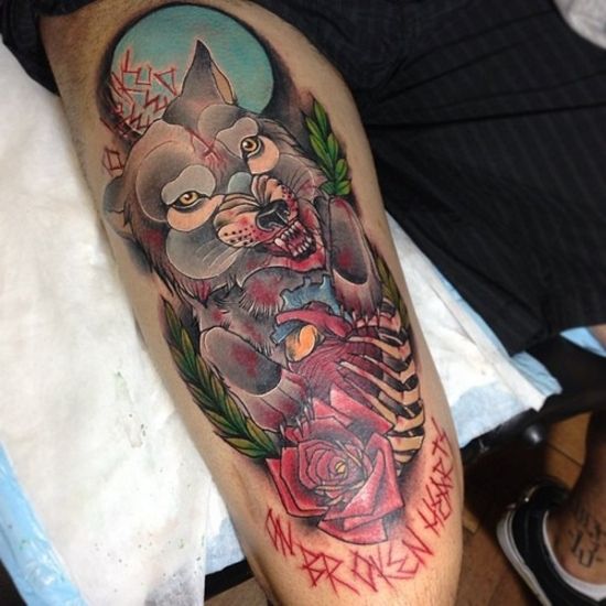 Red rose and angry wolf tattoo on leg