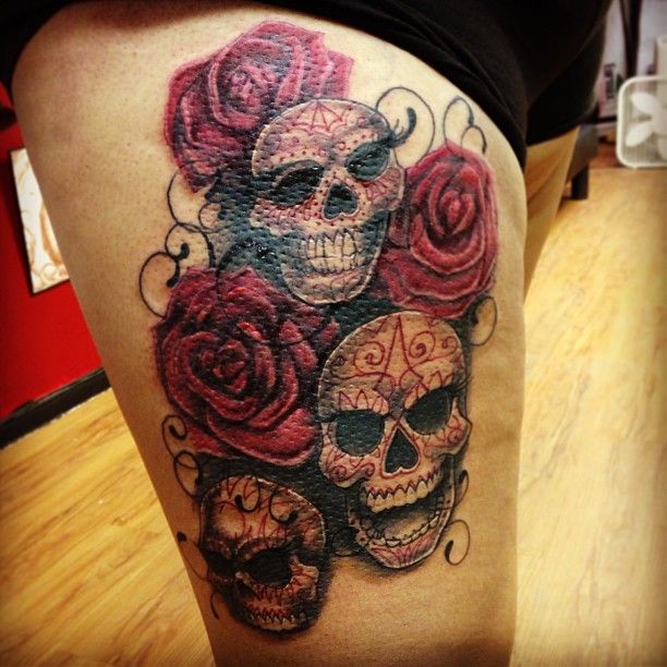 Red rose and skull tattoo on leg