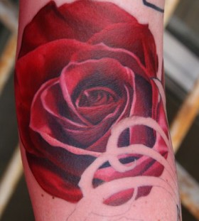 Red simple rose tattoo on arm