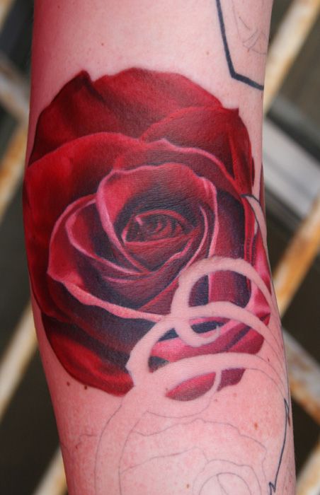 Red simple rose tattoo on arm