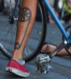 Red trainers and bicycle tattoo on leg