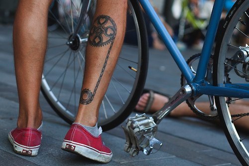 Red trainers and bicycle tattoo on leg