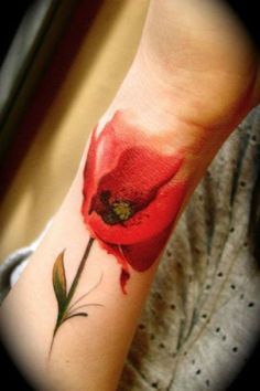 Red tulip tattoo on hand