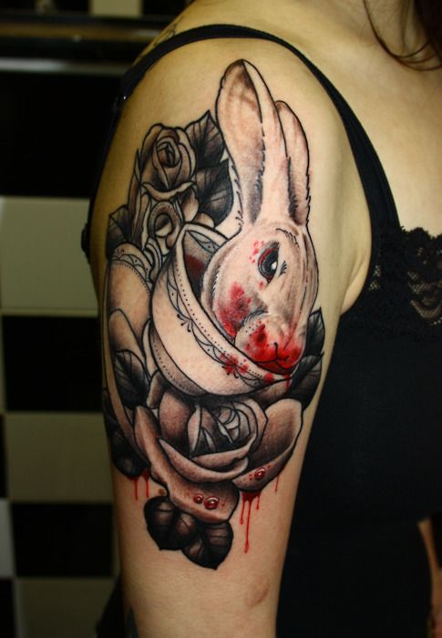 Rose, blood and rabbit tattoo on arm