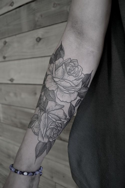 SImple black and white rose tattoo on arm