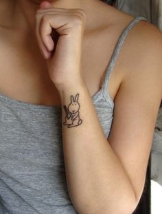 SImple black rabbit tattoo on body