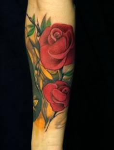 SImple red rose tattoo on arm