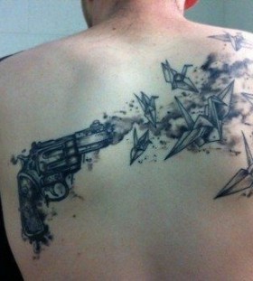 Scary gun and birds origami tattoo on shoulder